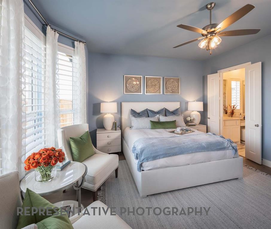 8903 Wildberry Road Oak Point, TX 75068 - Photo 11 of 31 a bedroom with a bed and a chandelier