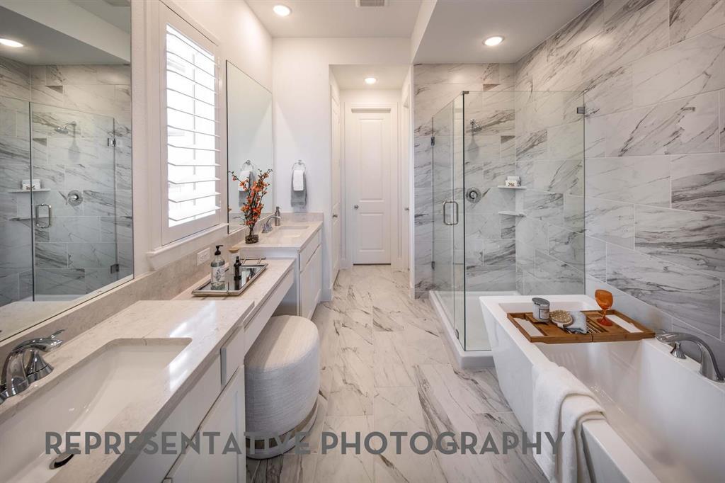8903 Wildberry Road Oak Point, TX 75068 - Photo 14 of 31 a spacious bathroom with a tub sink and mirror