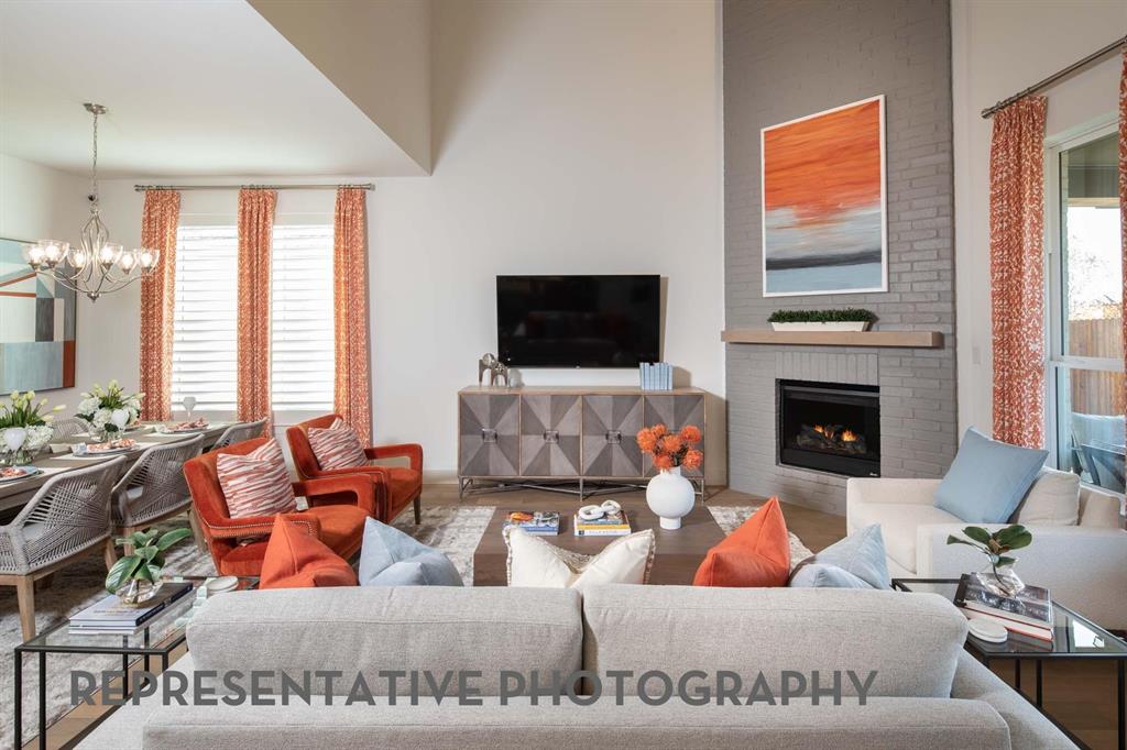 8903 Wildberry Road Oak Point, TX 75068 - Photo 2 of 31 a living room with furniture and a flat screen tv