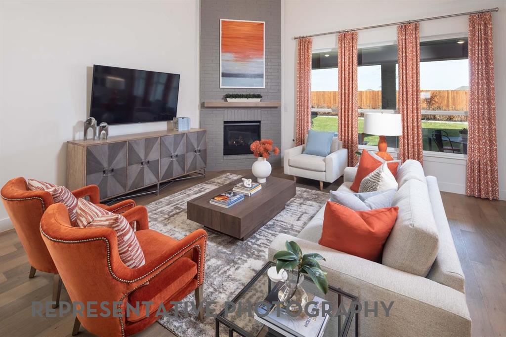 8903 Wildberry Road Oak Point, TX 75068 - Photo 9 of 31 a living room with furniture a flat screen tv and a fireplace