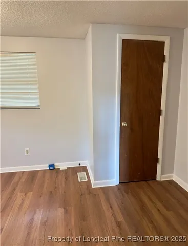 a view of a room with wooden floor