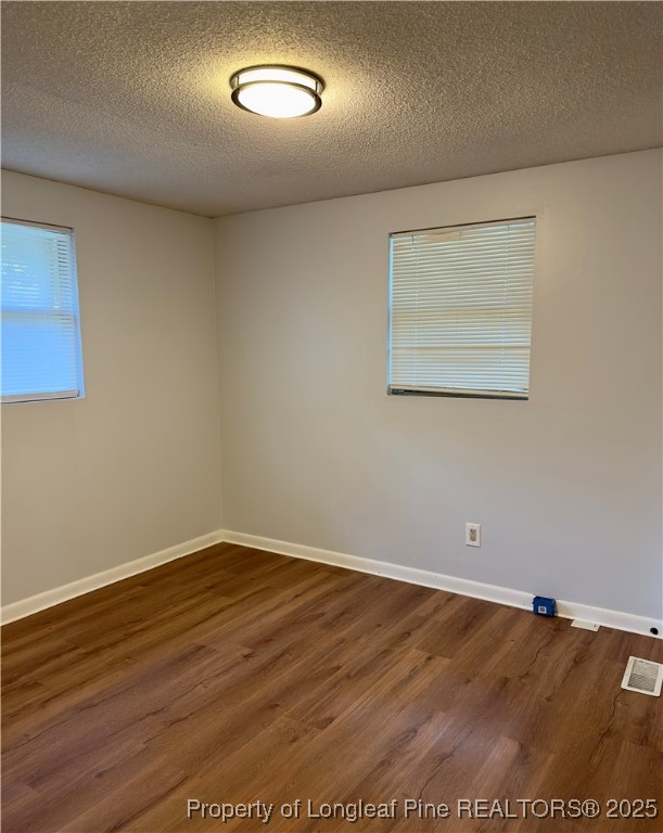 2357 A Watson Lake Road Fayetteville, NC 28306 - Photo 3 of 14 an empty room with wooden floor and windows