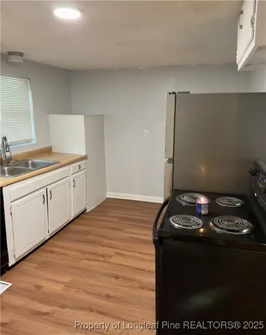 a kitchen with a sink and cabinets