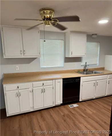 a kitchen with stainless steel appliances granite countertop a sink a stove a microwave and cabinets