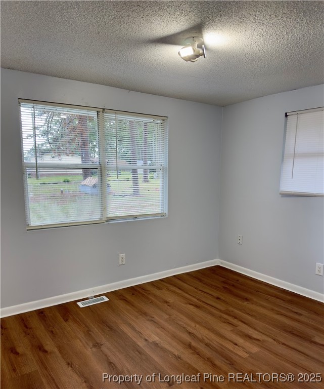 2357 A Watson Lake Road Fayetteville, NC 28306 - Photo 7 of 14 an empty room with wooden floor and windows