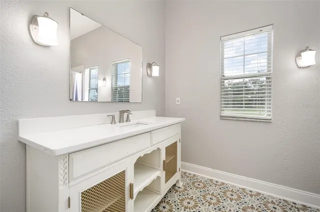 a bathroom with a sink vanity and a mirror