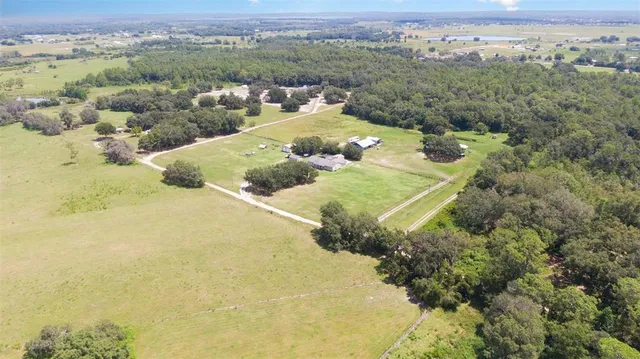 an aerial view of a house with a yard