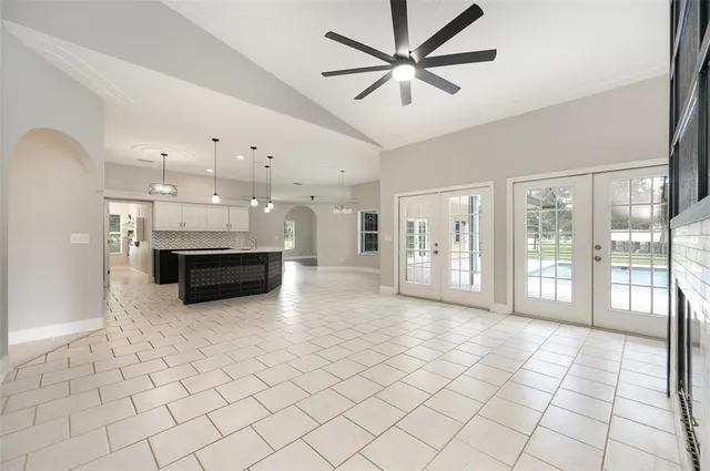a view of a electric appliances in kitchen and empty room with wooden floor