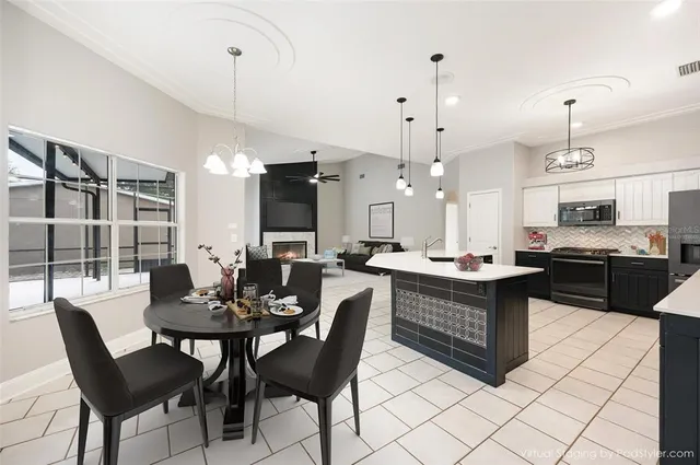 a kitchen with a dining table chairs and white cabinets