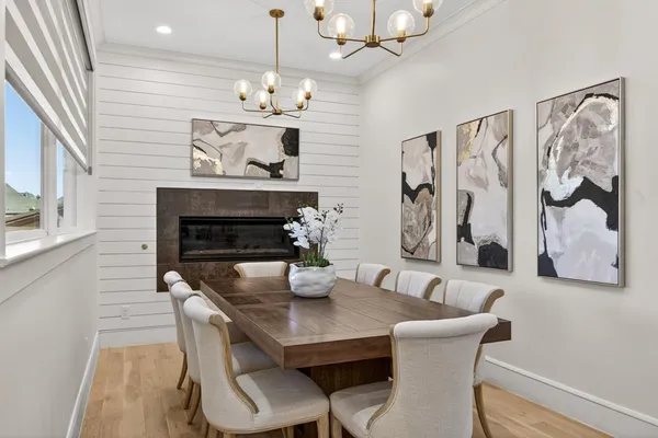 a dining room with furniture and chandelier