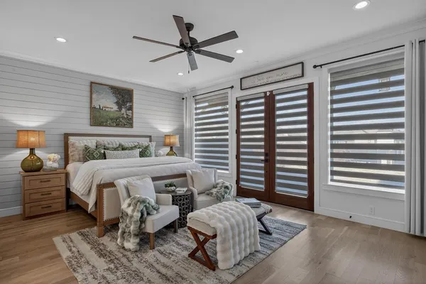 a bedroom with a large bed and a chandelier