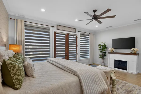 a bedroom with a large bed and a flat screen tv