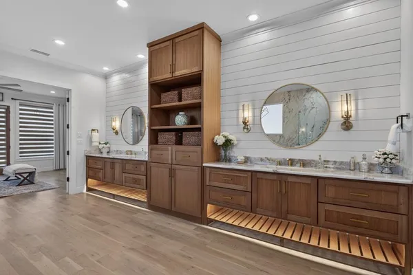 a bathroom with a double vanity sink and a mirror