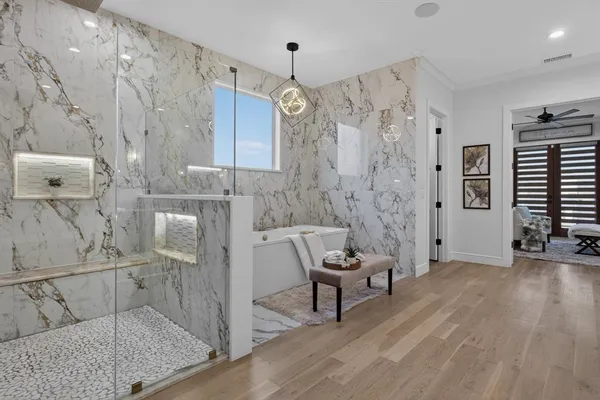 a spacious bathroom with a bathtub and shower