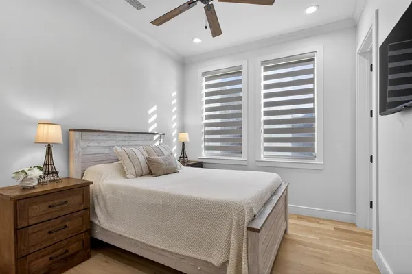 a bedroom with a bed and a night stand