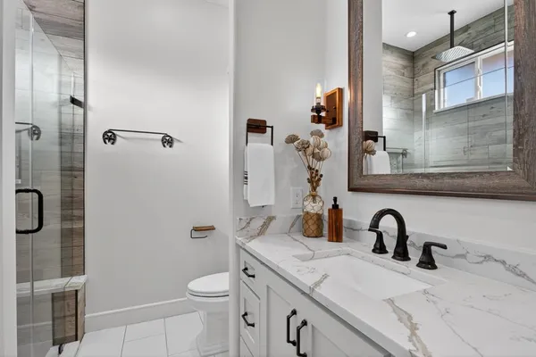 a bathroom with a sink toilet and shower