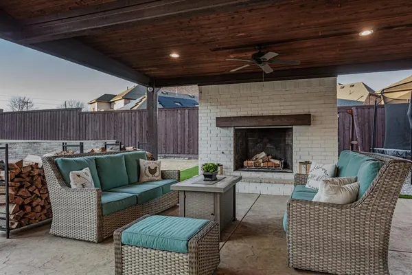 a living room with furniture a fireplace and a table