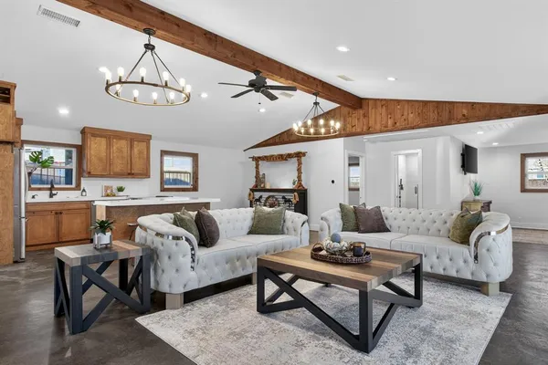 a living room with furniture kitchen view and a table