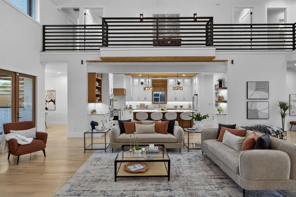 a living room with furniture a rug and a chandelier