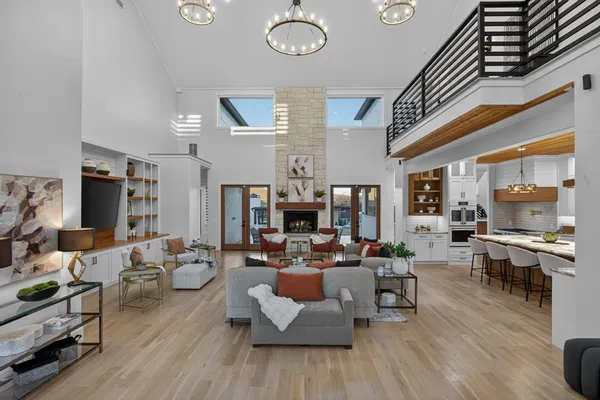 a living room with fireplace furniture and a wooden floor