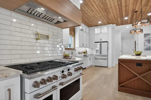 a kitchen with a stove and a refrigerator