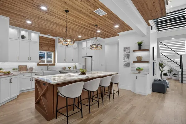 a kitchen with a sink stove and cabinets
