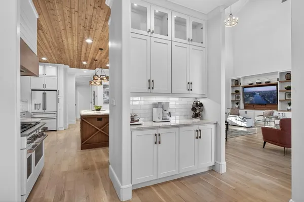 a view of a kitchen with furniture and wooden floor