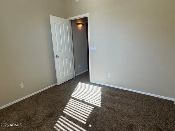 a view of a room with wooden floor and a carpet