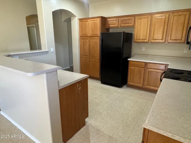 a kitchen with a refrigerator and a stove