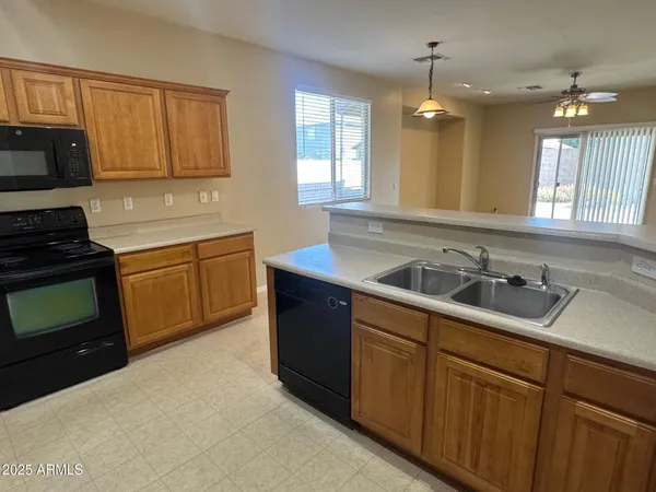 a kitchen with a sink stove and microwave