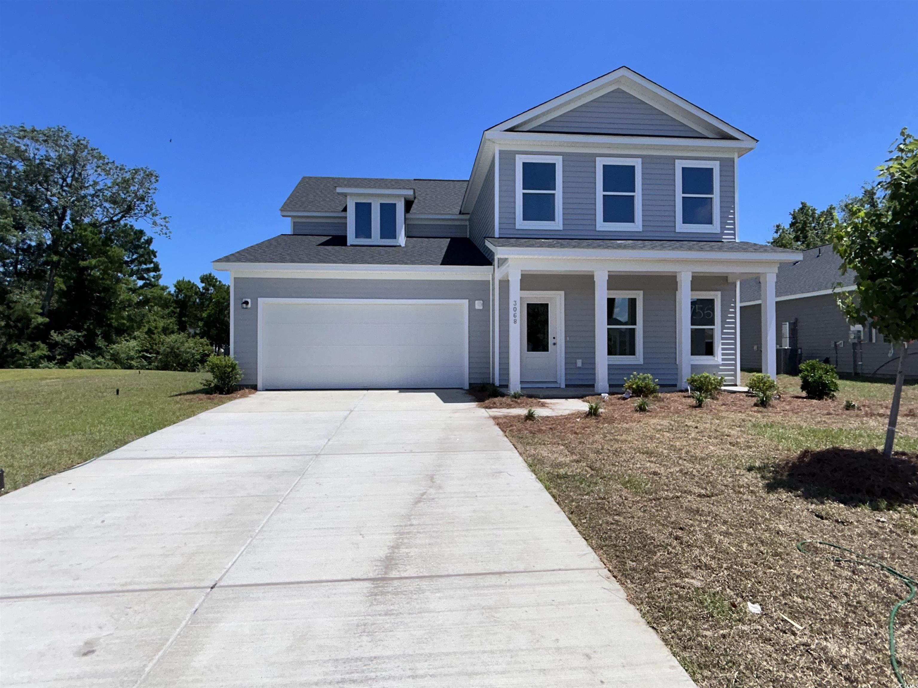 3068 Palma Way Myrtle Beach, SC 29579 - Photo 1 of 30 View of front of home featuring concrete driveway, an attached garage, covered porch, a shingled roof, and a front yard