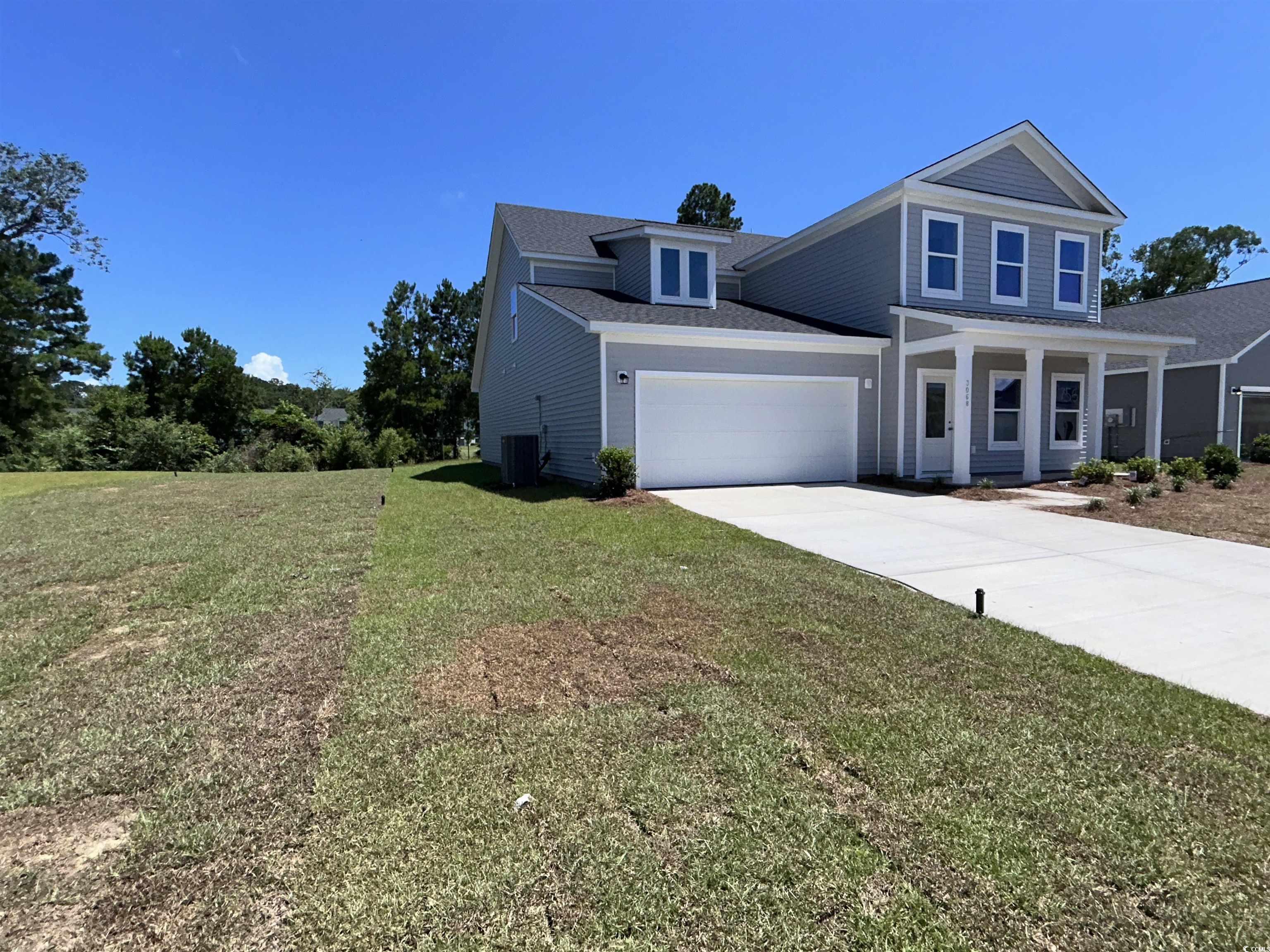 3068 Palma Way Myrtle Beach, SC 29579 - Photo 2 of 30 Traditional-style home with driveway, a front lawn, and an attached garage