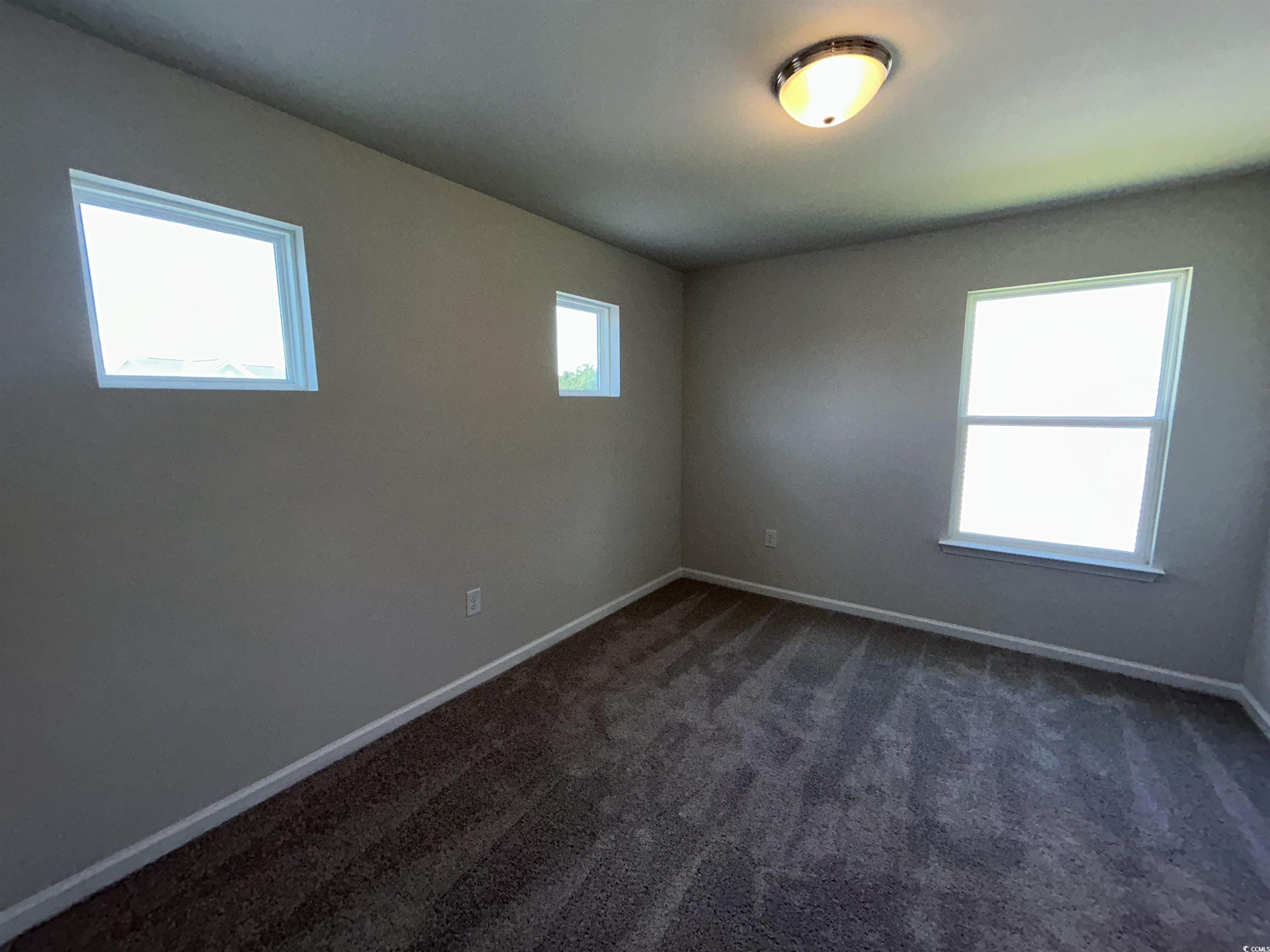 3068 Palma Way Myrtle Beach, SC 29579 - Photo 25 of 30 Empty room with baseboards and dark carpet