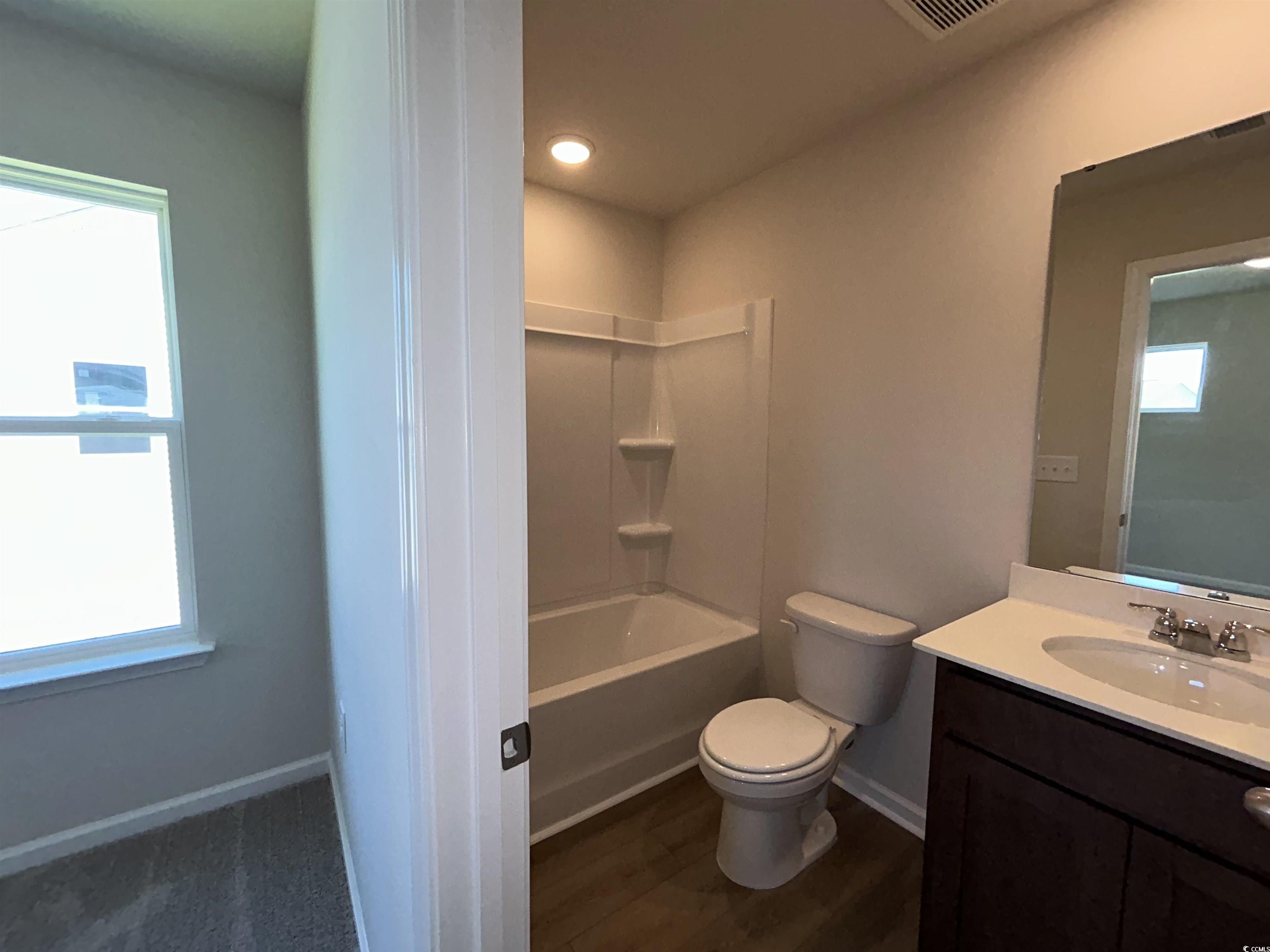 3068 Palma Way Myrtle Beach, SC 29579 - Photo 26 of 30 Full bath with vanity, wood finished floors, and shower / washtub combination