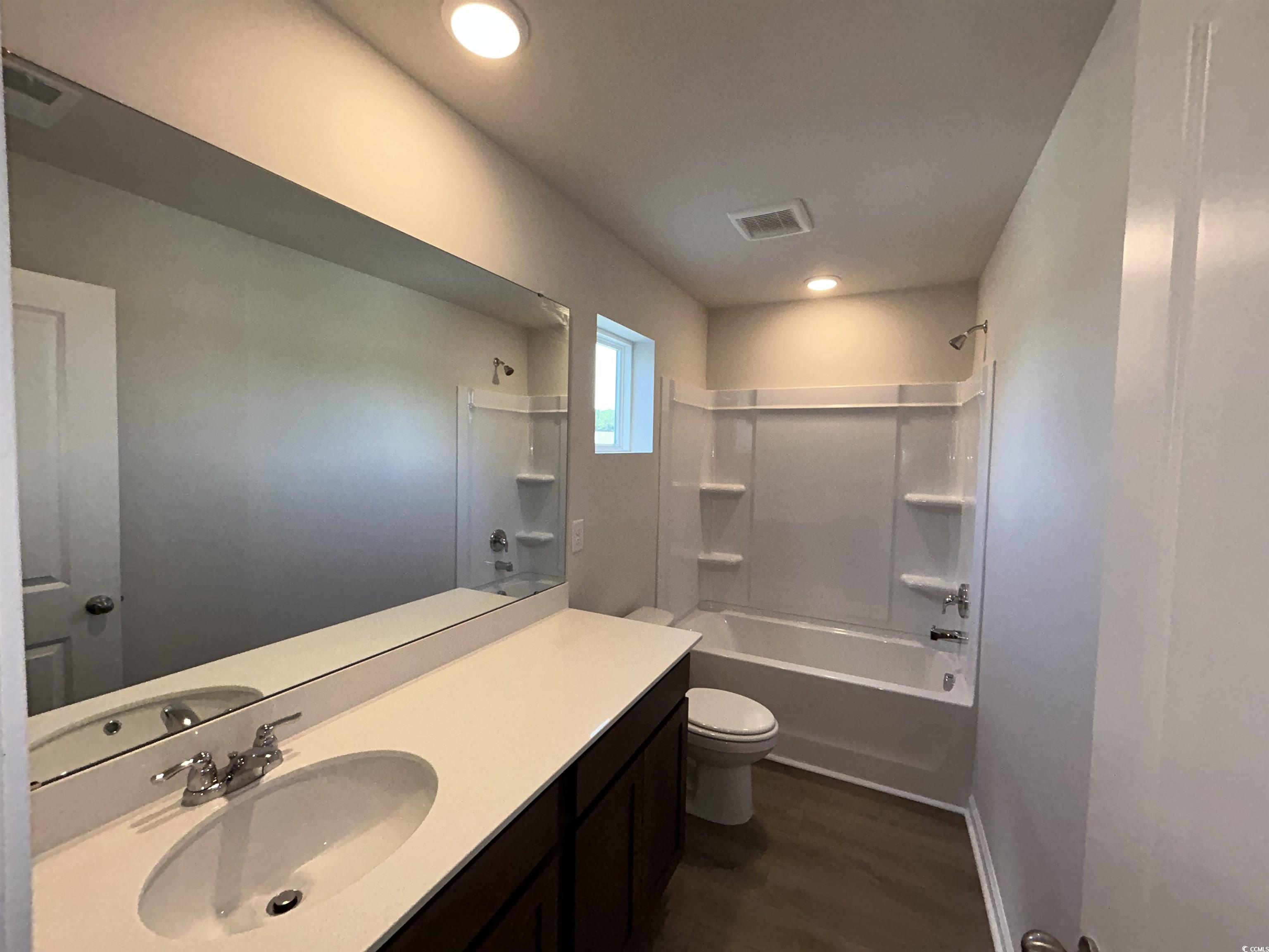 3068 Palma Way Myrtle Beach, SC 29579 - Photo 27 of 30 Bathroom featuring vanity, tub / shower combination, and wood finished floors