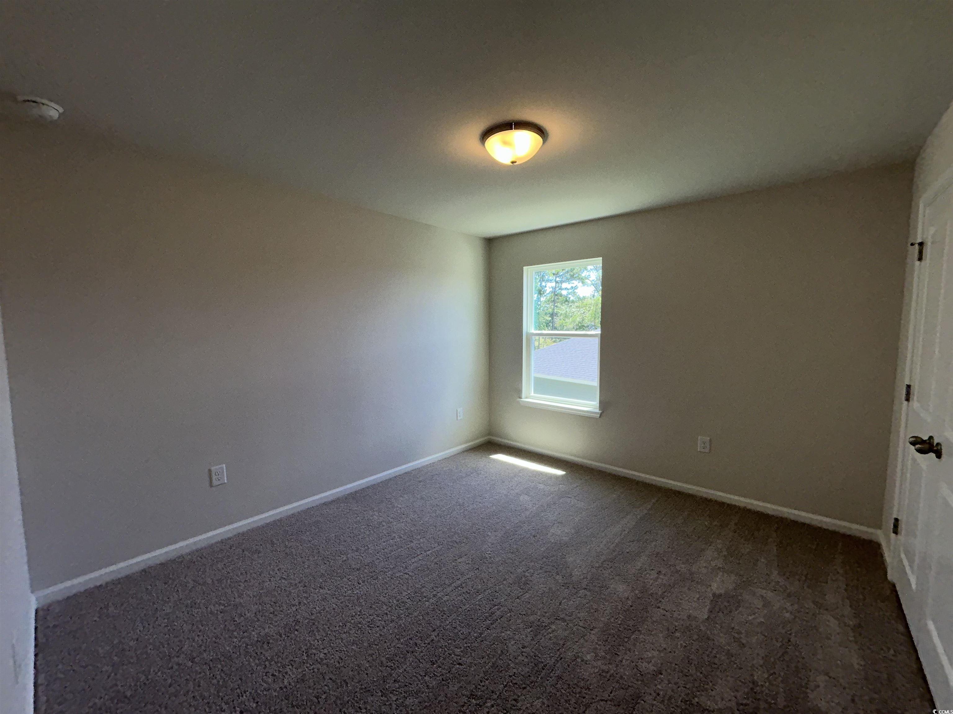 3068 Palma Way Myrtle Beach, SC 29579 - Photo 28 of 30 Spare room with dark carpet and a smoke detector