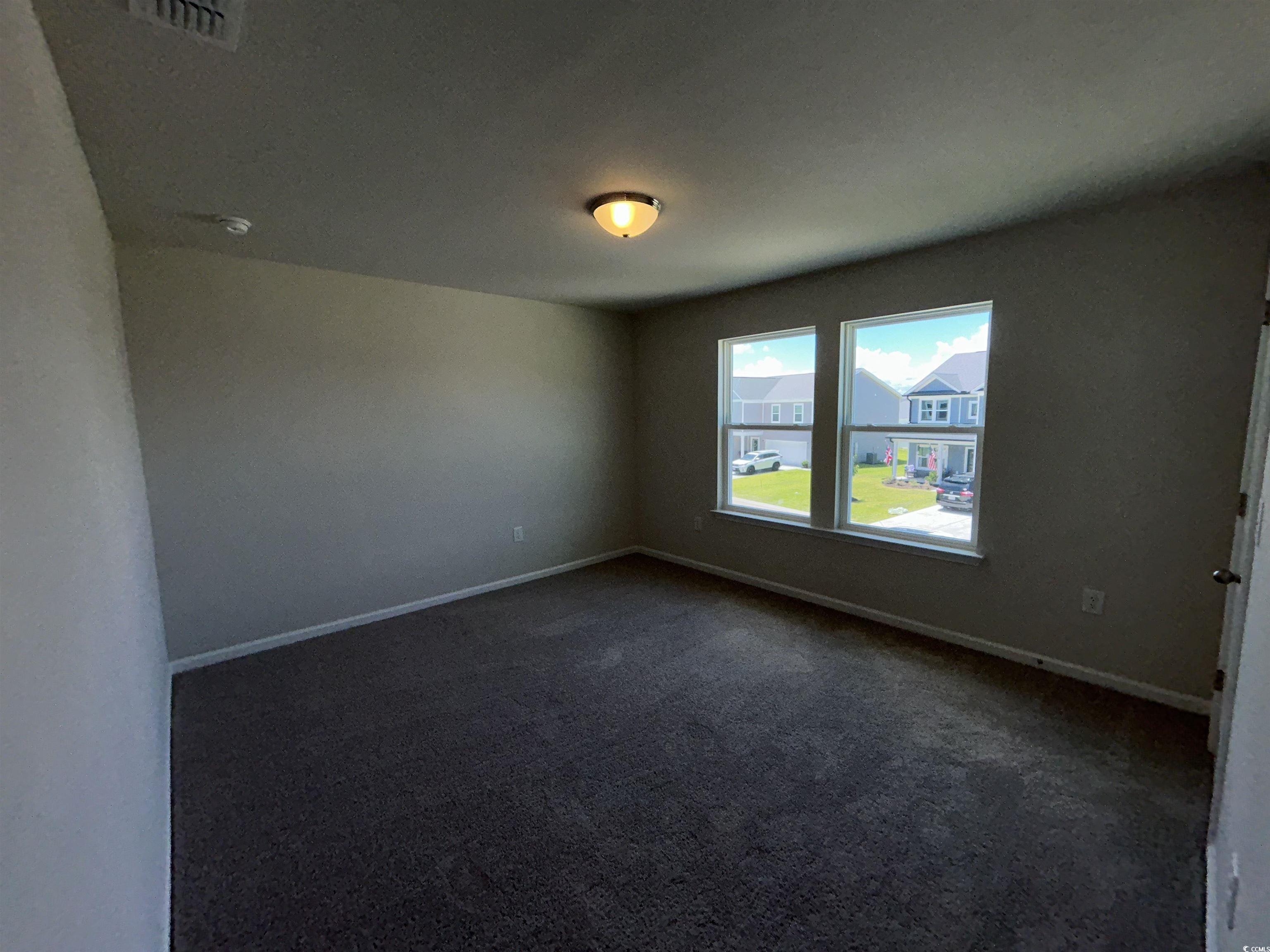 3068 Palma Way Myrtle Beach, SC 29579 - Photo 29 of 30 Spare room featuring dark carpet and baseboards