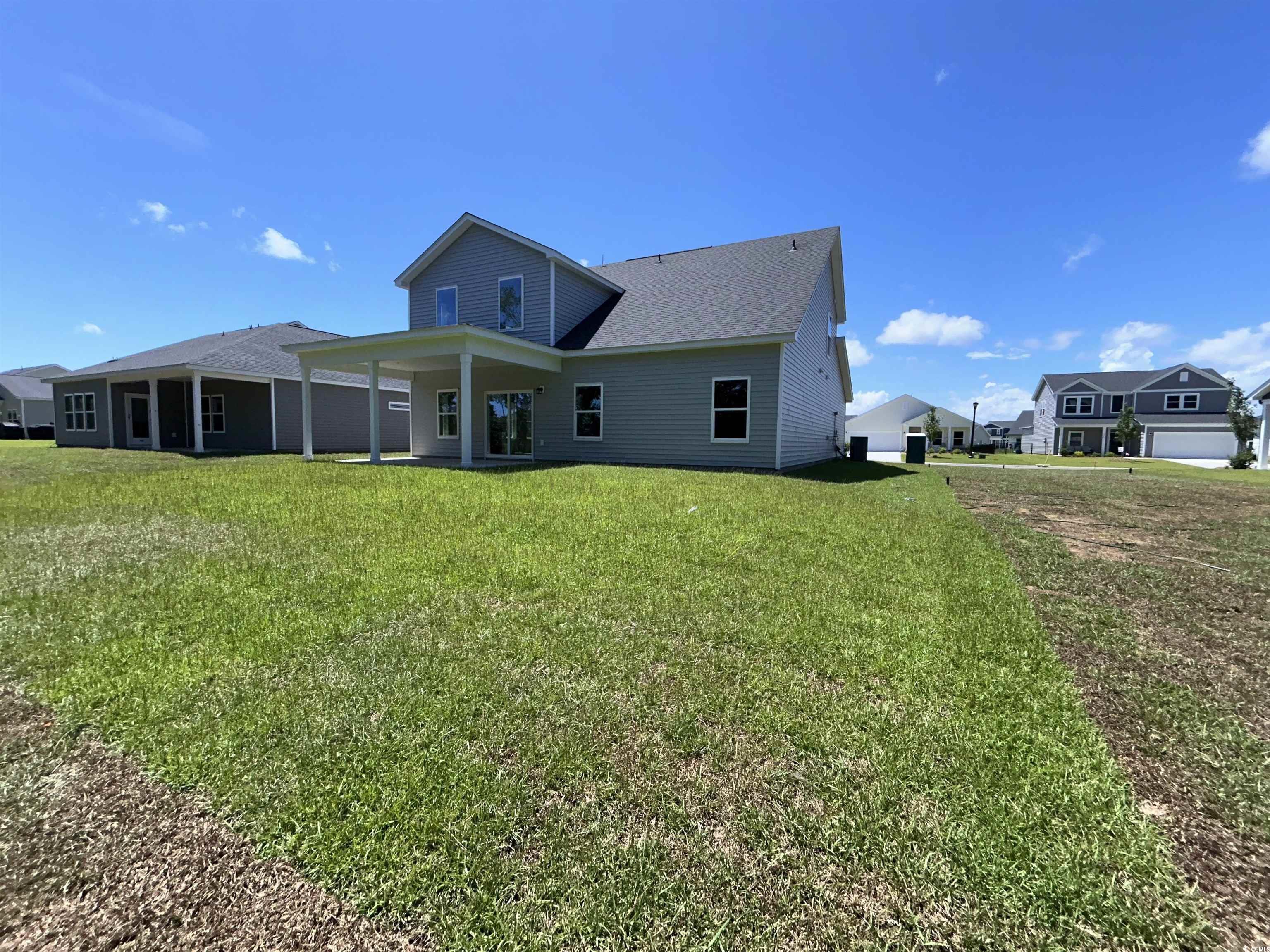 3068 Palma Way Myrtle Beach, SC 29579 - Photo 4 of 30 Back of property with a yard and a shingled roof
