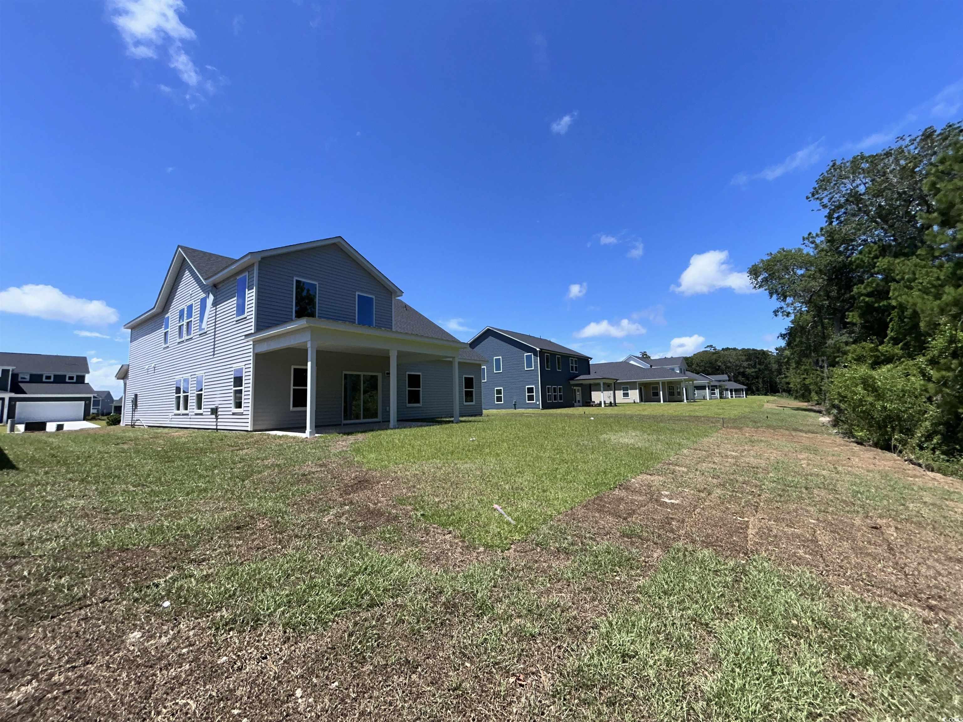 3068 Palma Way Myrtle Beach, SC 29579 - Photo 6 of 30 Back of house featuring a lawn