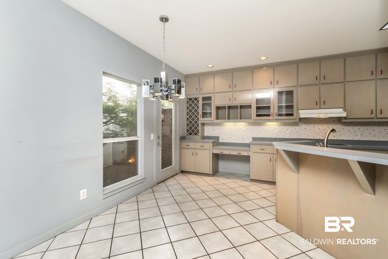 1205 Hillcrest Crossing East Mobile, AL 36695 - Photo 16 of 40 Kitchen with sink, decorative light fixtures, light tile patterned floors, decorative backsplash, and a notable chandelier
