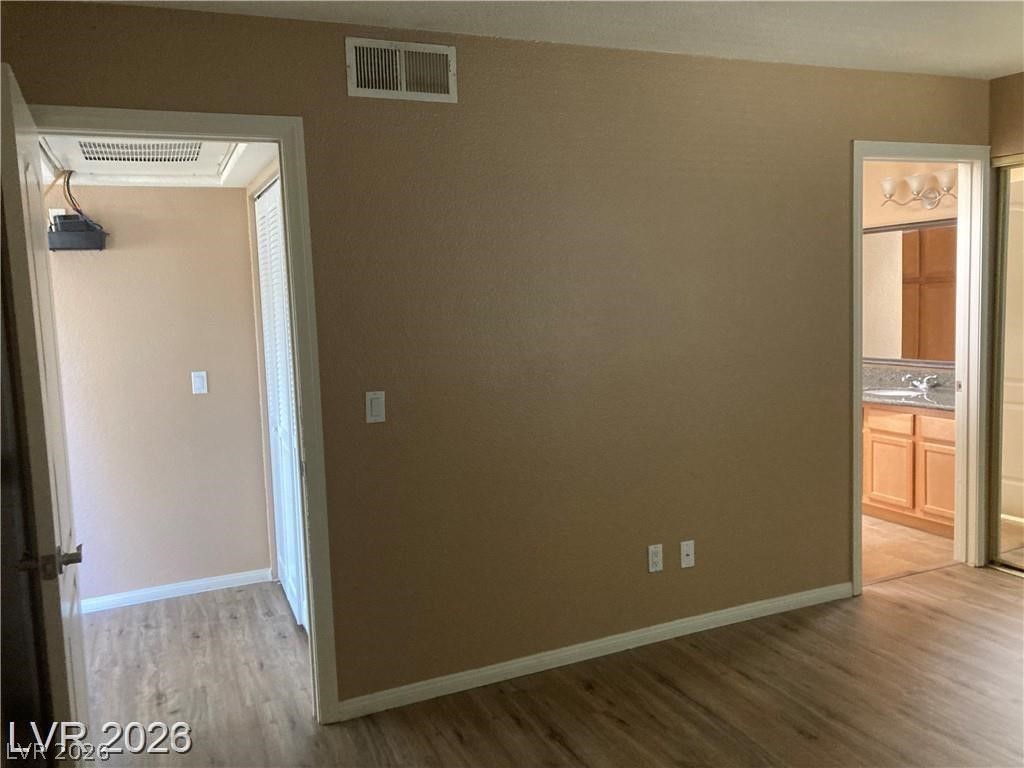 3145 East Flamingo Road, Unit 2100 Las Vegas, NV 89121 - Photo 16 of 34 Hardwood-style flooring extends into adjacent spaces, creating a seamless and adaptable living environment.