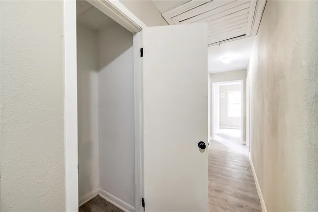 a view of an empty room and wooden floor