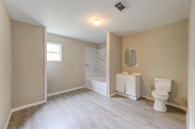 a bathroom with a bathtub and a toilet