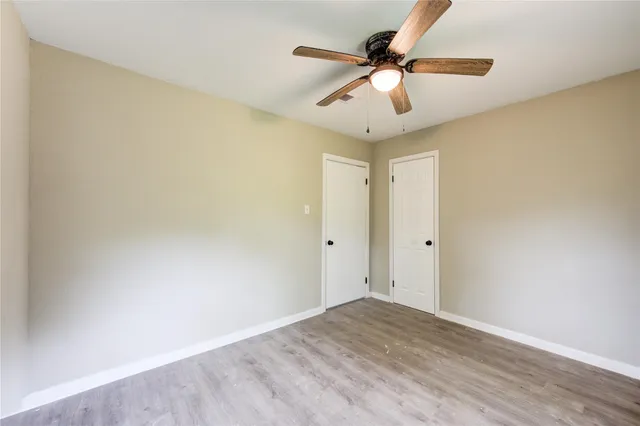 a view of a room with wooden floor