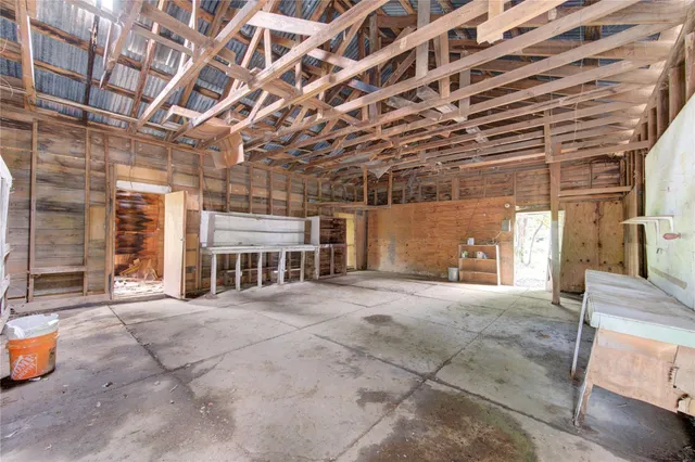 a view of an empty room with a brick wall