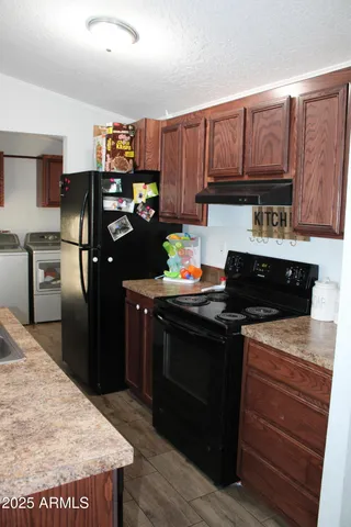 a kitchen with a stove and a refrigerator