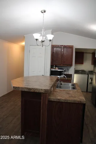 a kitchen with a counter space cabinets and appliances