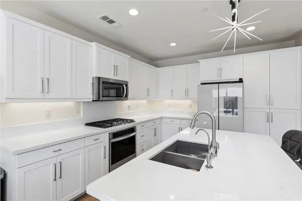 a kitchen with a sink stove and microwave