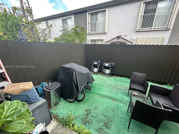 a view of a chairs in backyard of the house