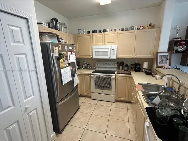 a kitchen with stainless steel appliances a stove a sink and a refrigerator